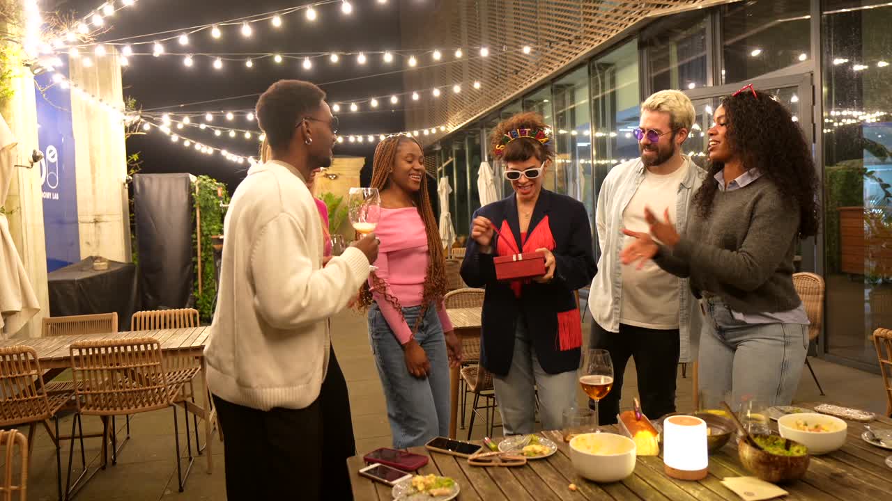 Friends Celebrating a Birthday with a Gift at a Party