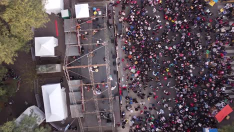 descending aerial top down shot chacarera folk dance on stage in street of buenos aires - people celebrating show outdoors