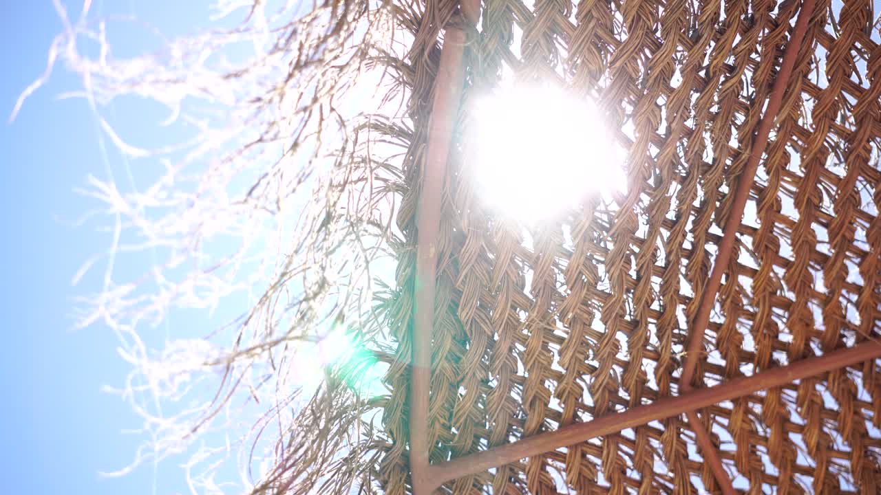 Sun rays and breeze passing beach umbrella