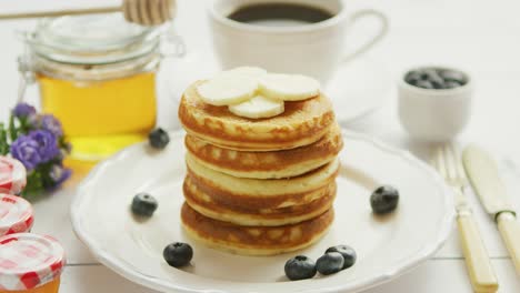 pancakes with slices of banana and berries