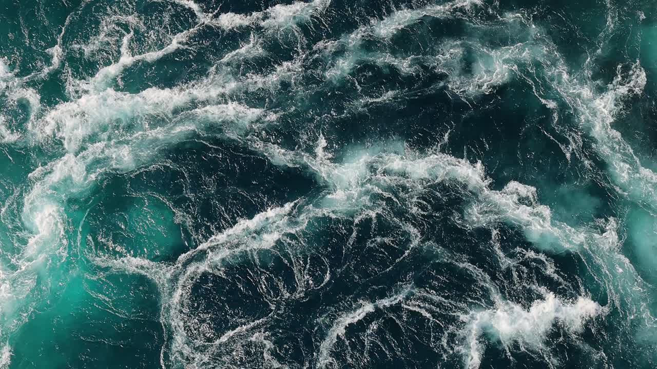 Blue waves of water of the river and the sea meet each other during high tide and low tide.