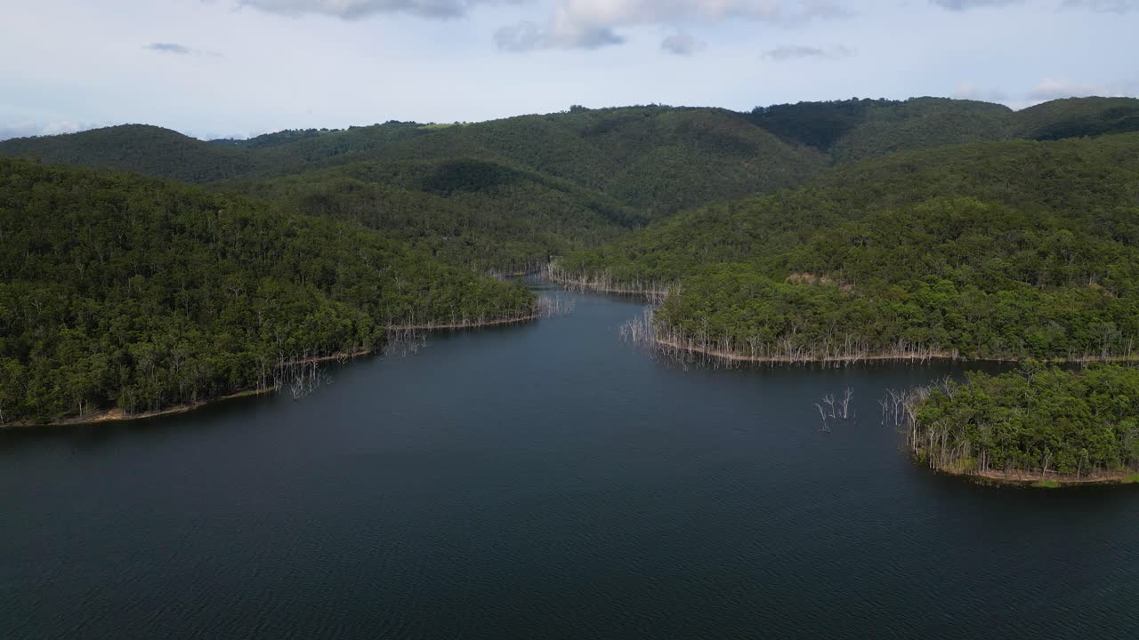 Right to left aerial views of Advancetown Lake near the Western Boat Ramp on the Gold Coast Hinterland.