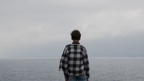 boy standing on the coast