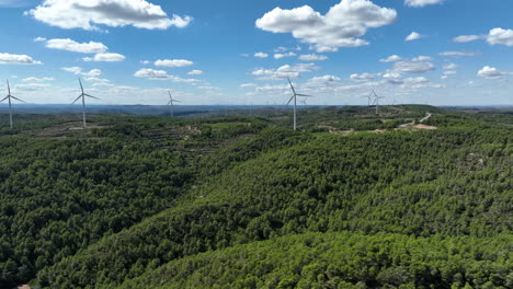 prores footage of wind turbine for eolic energy production on green mountain of coll de moro, catalonia in spain