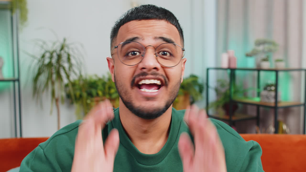Excited arabian man surprised shocked by sudden victory good win news celebrating wow reaction