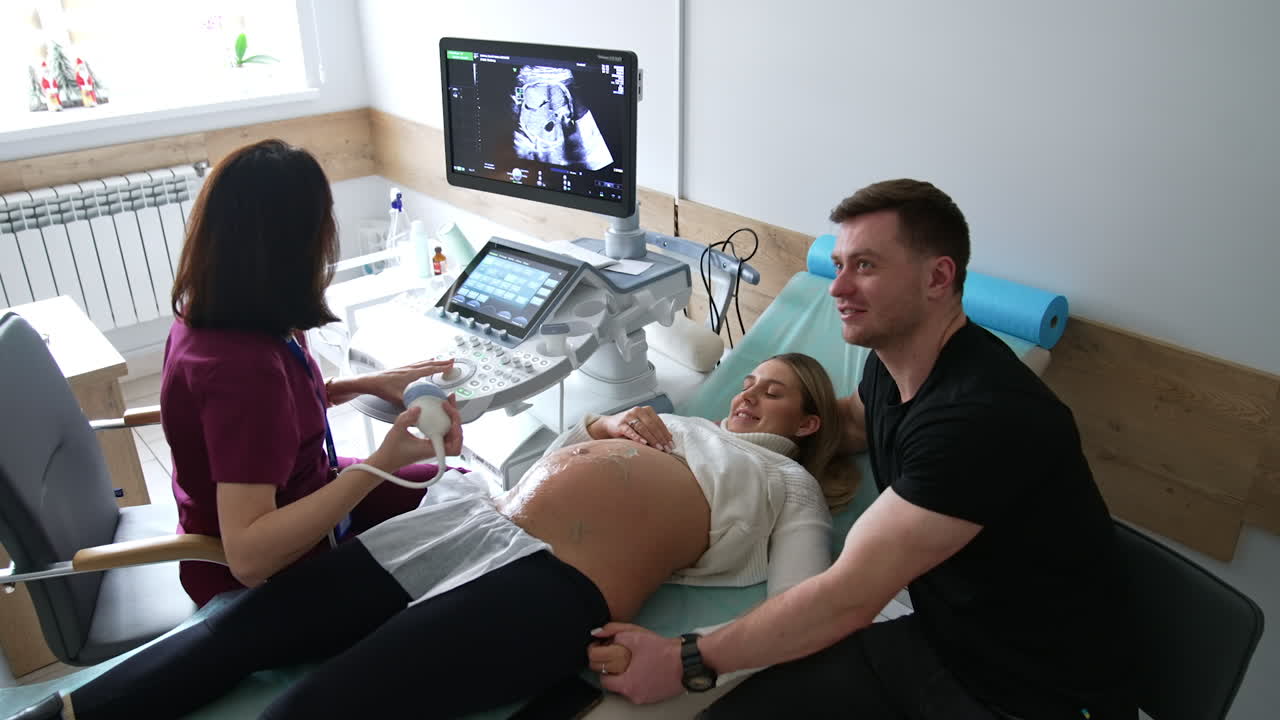 Pregnant couple undergoing an ultrasound scan