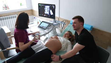 pregnant couple undergoing an ultrasound scan