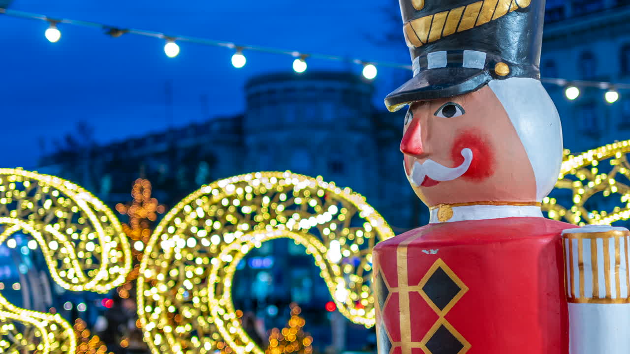 Nutcracker decoration with Christmas lights on the background in the evening