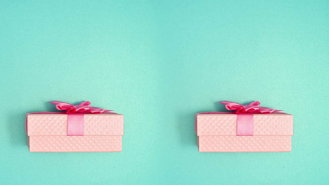 Double pink gift with ribbon open on cyan background. Stop motion animation
