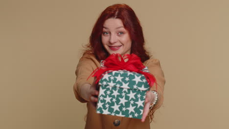 woman presenting birthday gift box stretches out hands, offer wrapped present career celebrate bonus