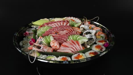 sushi platter being arranged and garnished.