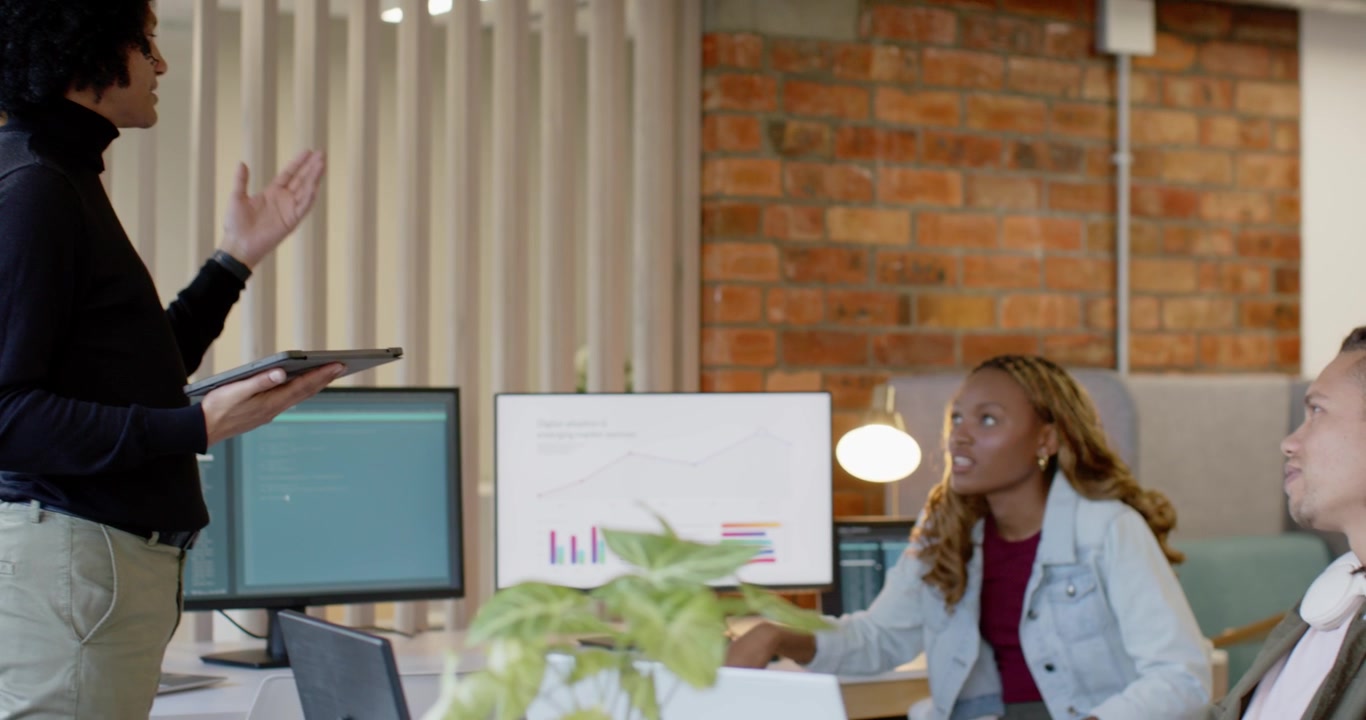 African American woman leading with tablet raising palm to screens showing data at work, copy space