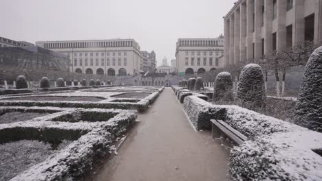 steady pov shot of snowy jardin de mont des arts during snowfall in brussels, belgium