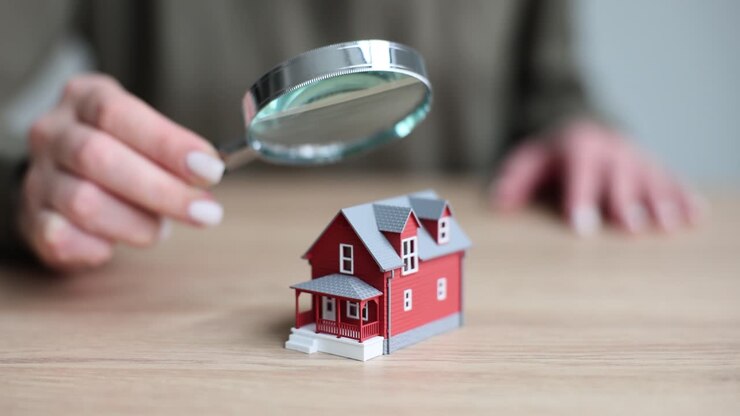 Examining a Miniature House with a Magnifying Glass