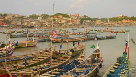 wooden fishing boats with flags in sea harbor at cape coast in ghana