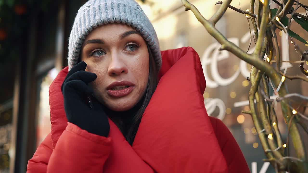 Woman in Red Coat Talking on Phone in Winter