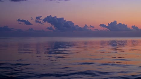 a serene sunset over calm waters, captured in a wide-angle shot