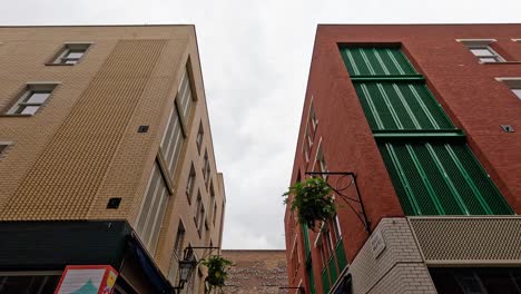 a person walks past colorful storefronts