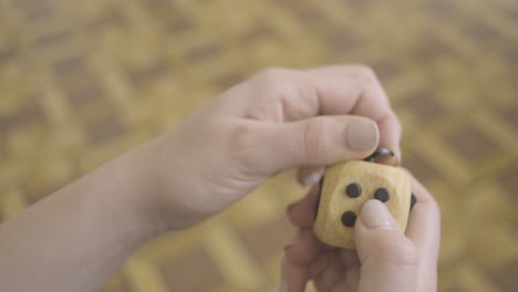 woman's hands playing with a fidget cube toy