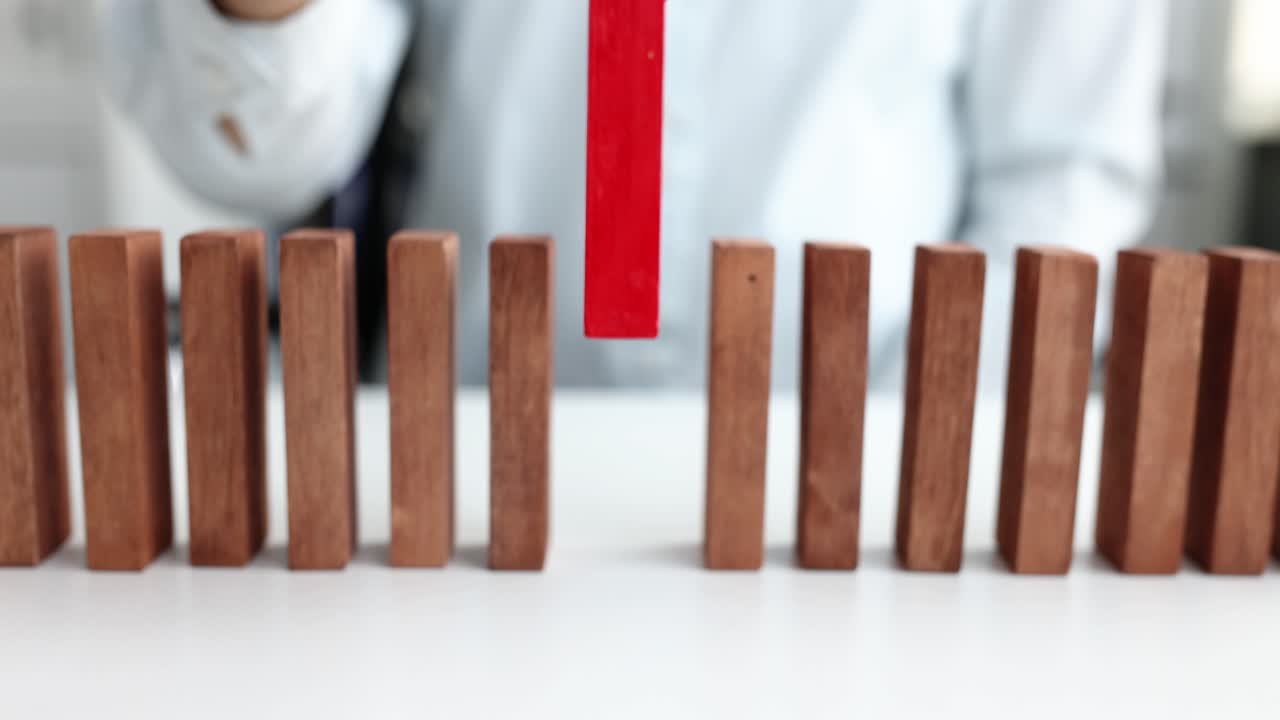 Female hand putting red block in front of wooden closeup 4k movie slow motion