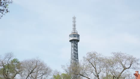 Petrin-Lookout-Tower-in-petrin-gardens-In-Prague,-Czech-Republic,-tilt-up-shot