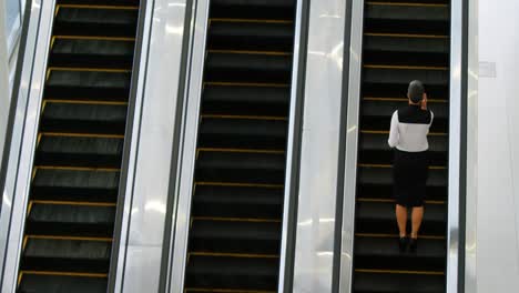 businesswoman using escalator while talking on mobile phone 4k