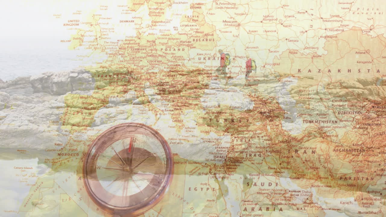 Couple hiking rocky coastline using vintage map overlay with animated compass for travel marketing