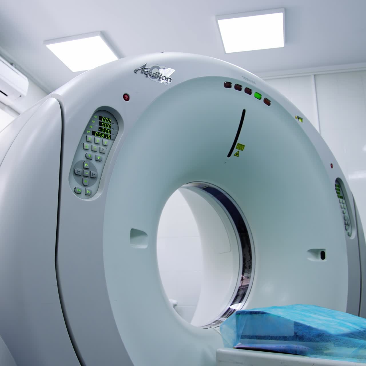 CT scan in the empty hospital room. Gradual distancing from a modern technological tomography equipment. Low angle view