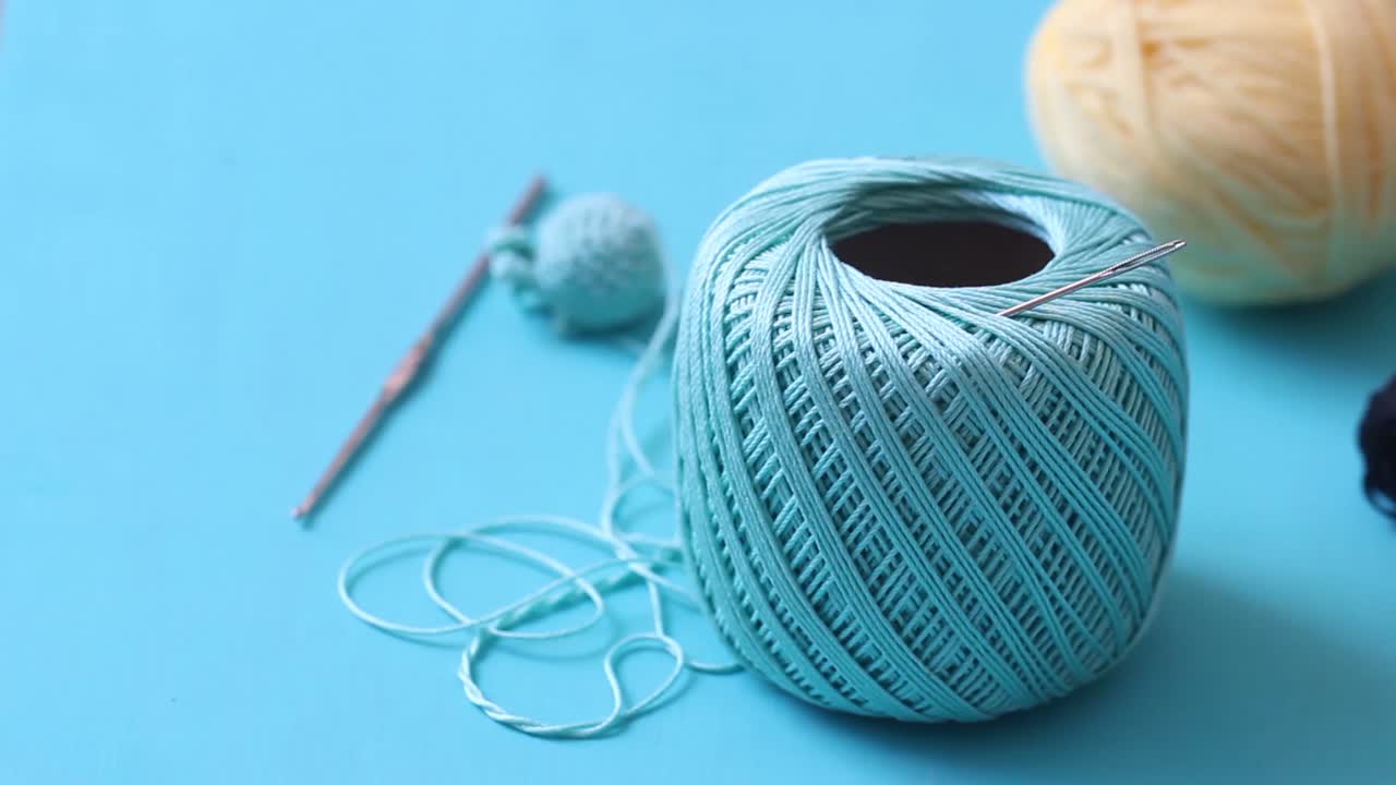 cotton thread for knitting in blue backgound.