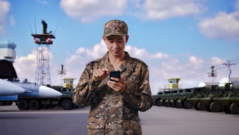 soldier using a smartphone at a military base