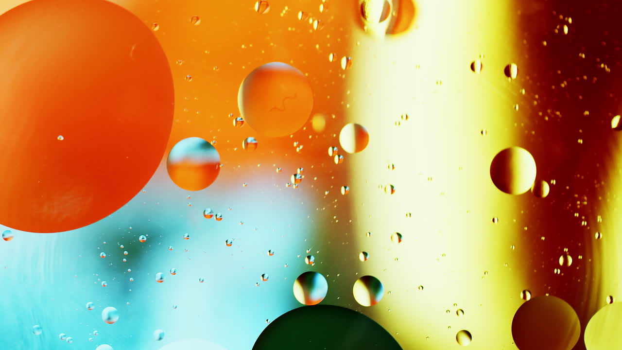 Real close up oil bubbles in water rotation with color gradient abstract mixing background