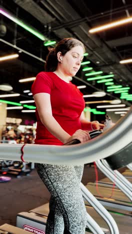 Woman walking on a treadmill at the gym