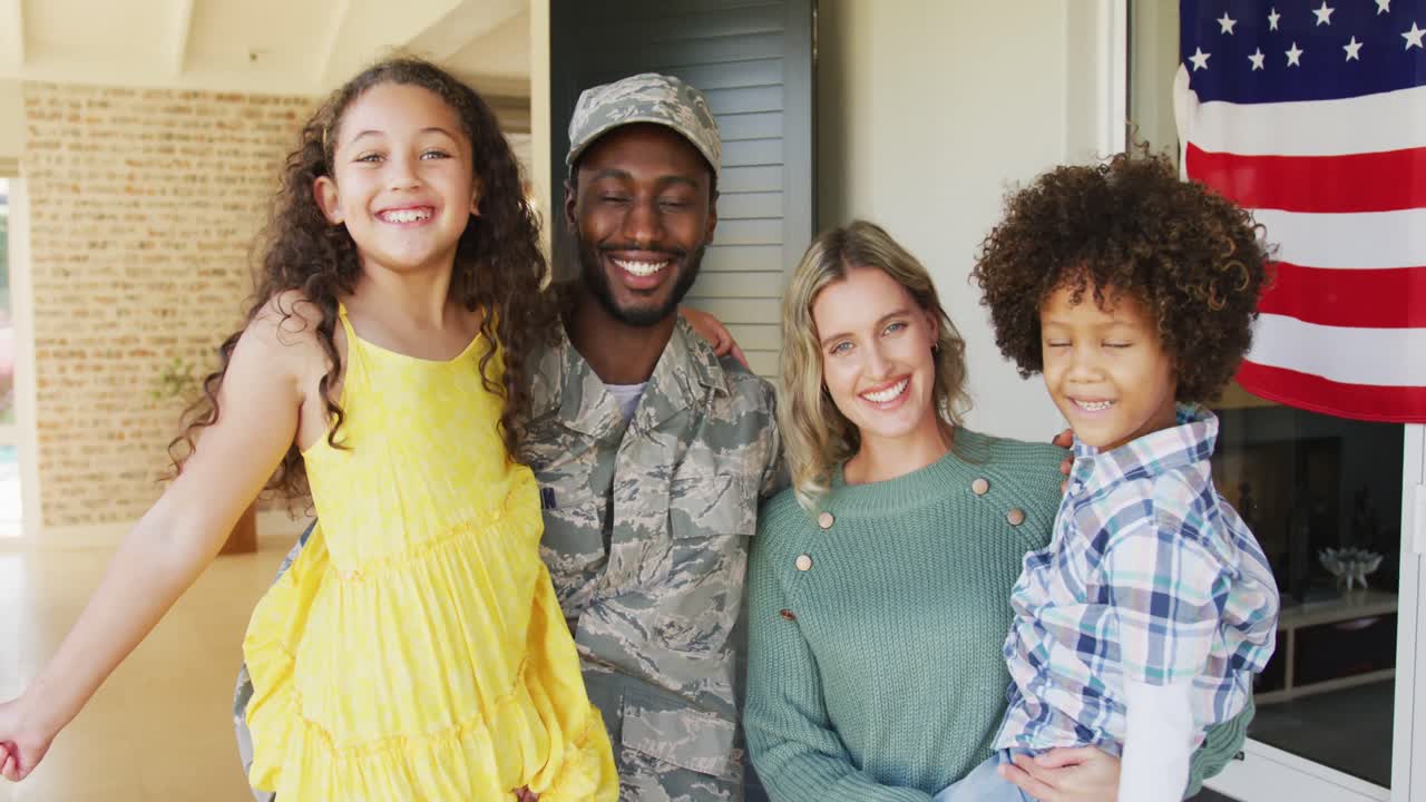 Video of happy diverse family standing outside of house