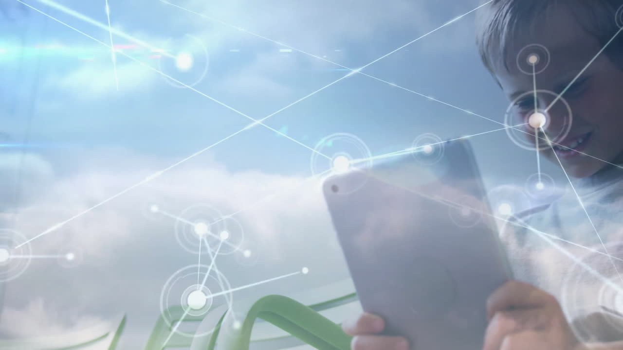 Boy using tablet, showing glowing network connections over cloudy sky for technology demo
