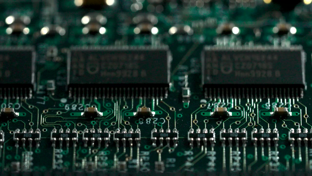 Close up shot of a notebook motherboard with lighting reflecting on microchips and circuits.