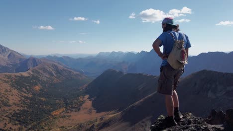 hiker on peak admiring mountain range kananaskis alberta canada