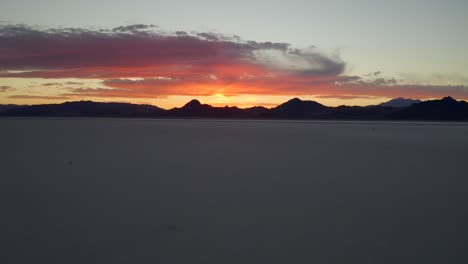 Epic-picturesque-fire-sunset-at-bonneville-salt-flats-aerial-dolly