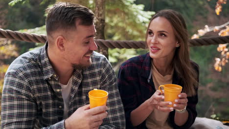 couple enjoying a drink in the forest