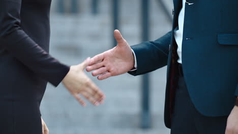 Portrait business partners meeting together. Businessmen shaking hands outdoors