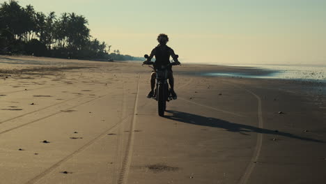 motorcycle ride on a beach at sunrise/sunset