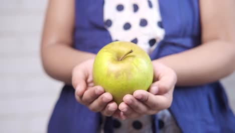 child holding a green apple