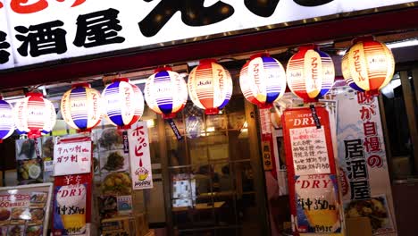 lanterns glow outside a traditional japanese tavern