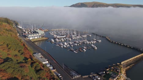 carlingford marina on a misty morning by the fjord in dundalk, ireland. - aerial shot