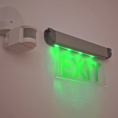 exit sign points the way out of building