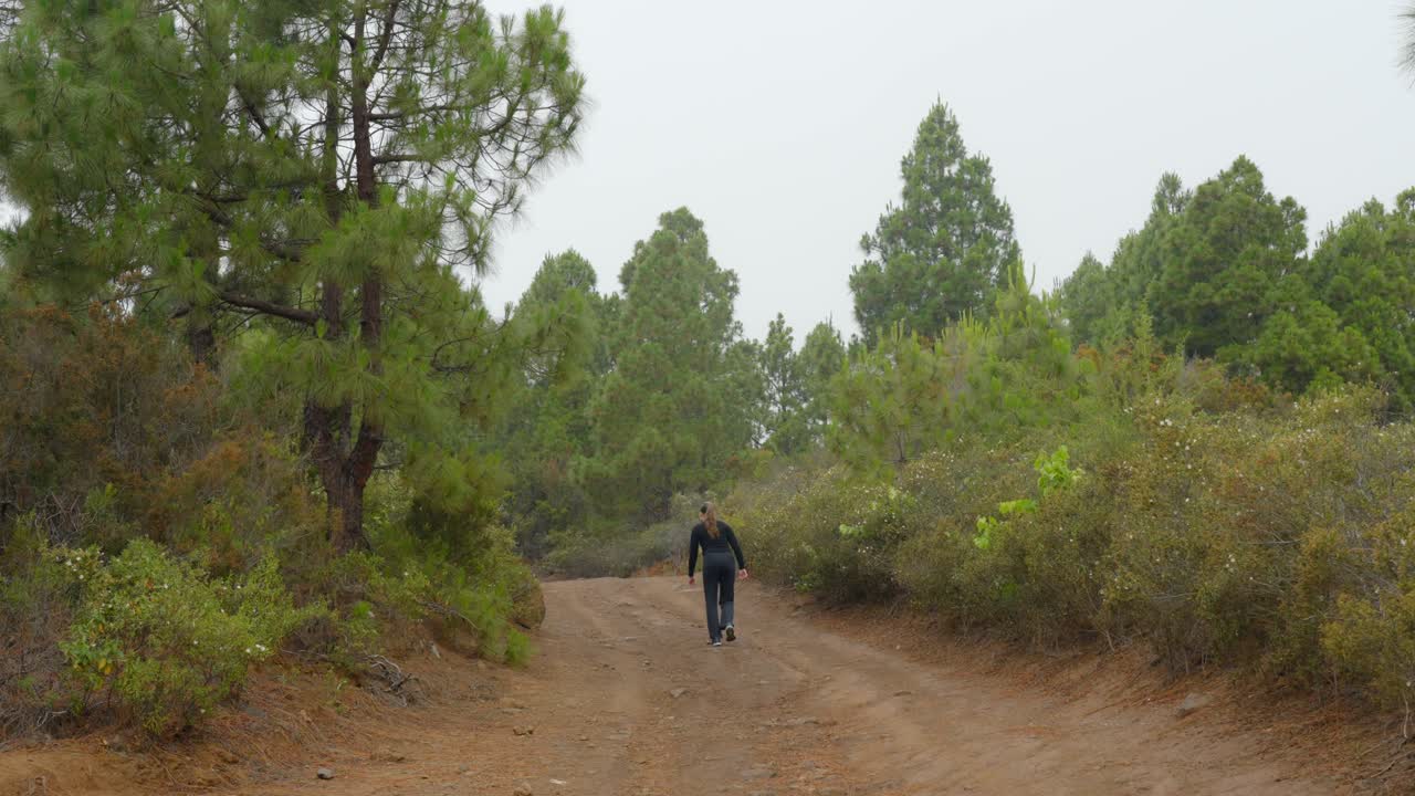 A woman walking on an empty path towards Guimar valley, Tenerife, Canary Island