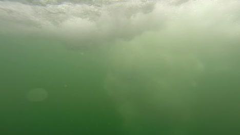 young man cliff jumping in australia. view from under