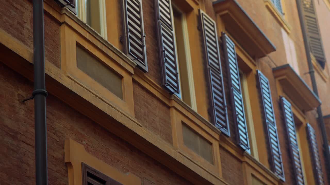 Italian Building Facade with Brown Shutters