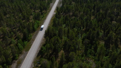 Aerial-view-tilting-in-front-of-a-RV-driving-in-the-Vatsari-wilderness-of-Lapland