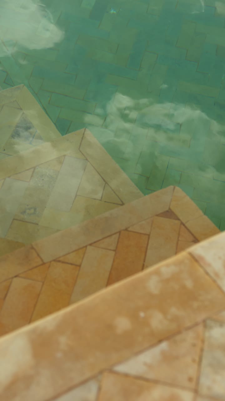 Calm water scene with tiled floor in Marrakesh, serene and tranquil vibe