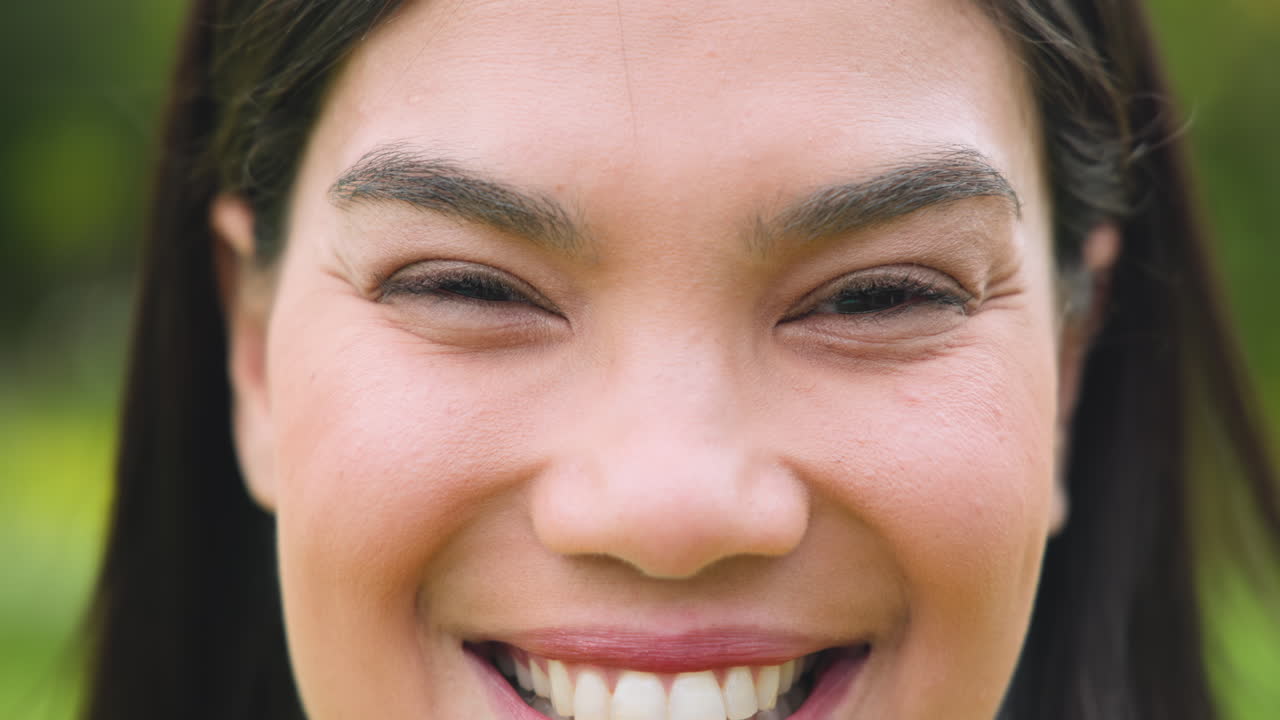 Smiling woman enjoying outdoor holiday gathering with family and friends